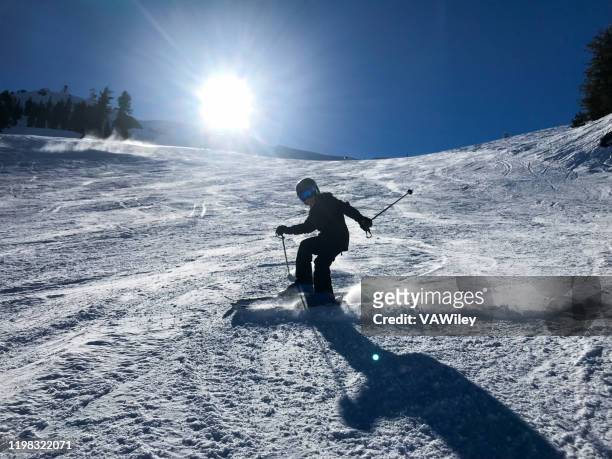 child learning to ski and snowshoe on a beautiful tahoe day in california. - lake tahoe skiing stock pictures, royalty-free photos & images
