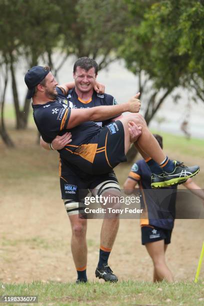 James Slipper of the Brumbies is carried by team mate Murray Douglas during the Brumbies Super Rugby training session at Newcastle University on...