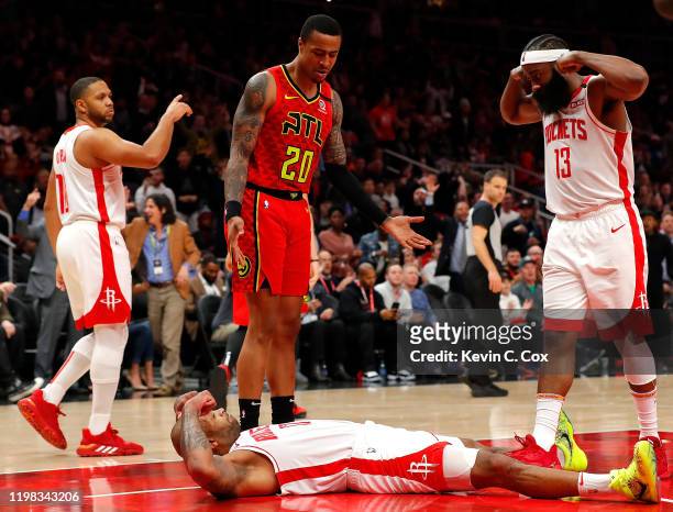 Tucker of the Houston Rockets reacts towards James Harden after drawing a charge from Alex Len of the Atlanta Hawks to force a turnover in the second...