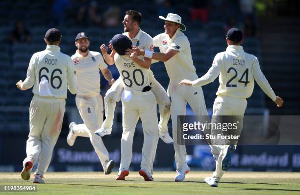 England bowler Mark Wood is congratulated by team mates after dismissing Rassie van der Dussen during Day Four of the Fourth Test between South...