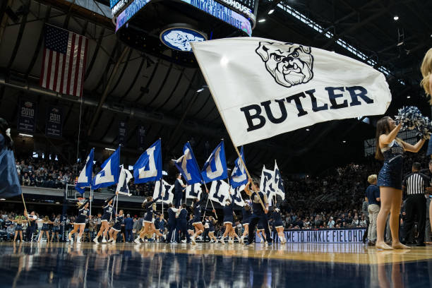Butler University cheerleaders wave a flag on the court during the men's college basketball game between the Providence Friars and Butler Bulldogs on...
