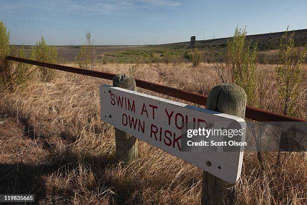 Warning to swimmers is posted along the shore of the dried O.C. Fisher Lake on July 25, 2011 in San Angelo, Texas. The 5,440 acre lake which was...