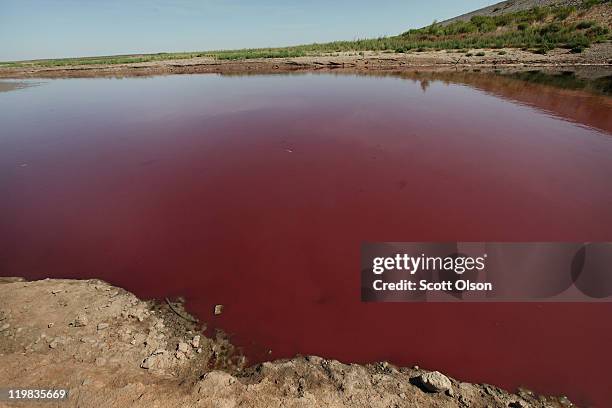 Small pool of red sludge-like water, only water that remains in O.C. Fisher Lake, sits at the base of the dam July 25, 2011 in San Angelo, Texas. The...