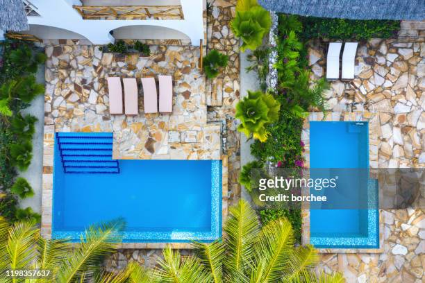 aerial view on luxury bungalows in zanzibar - private island stock pictures, royalty-free photos & images