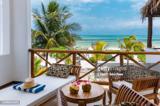 beachfront bungalow with sea view - beach holiday stock pictures, royalty-free photos & images