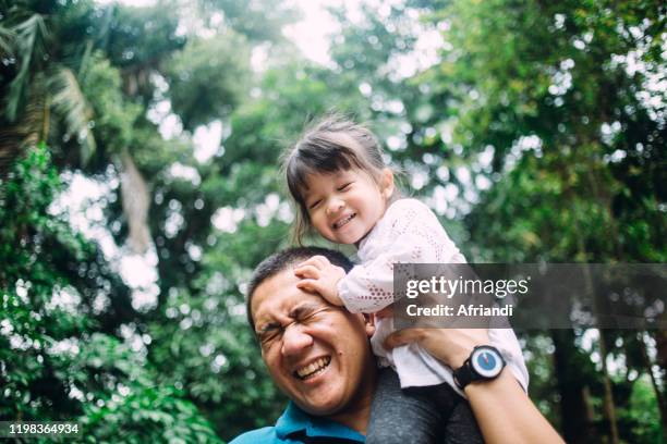 father playing with daughter - indonesia family imagens e fotografias de stock