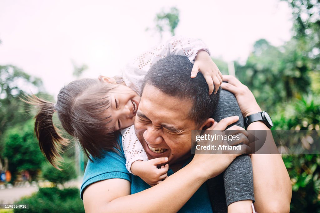 Daughter playing with her father