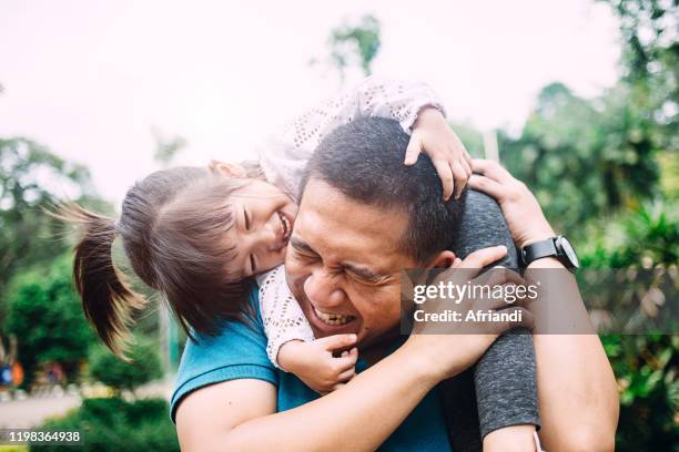 daughter playing with her father - malay archipelago stock pictures, royalty-free photos & images