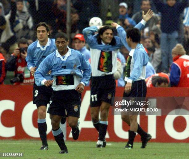 Federico Magallanes of Uruguay is congratulated by teammates after scoring his team's winning goal over Brazil in a World Cup 2002 qualifier that...