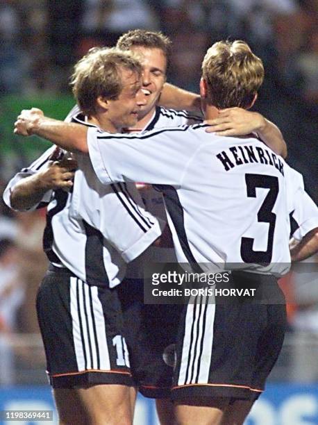 German players Oliver Bierhoff and Jorg Heinrich congratuate their captain Jurgen Klinsmann after Klinsmann scored the second goal 25 June at the...