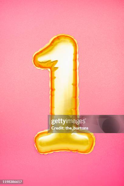 gold colored number one on pink background - about you awards in hamburg stock pictures, royalty-free photos & images