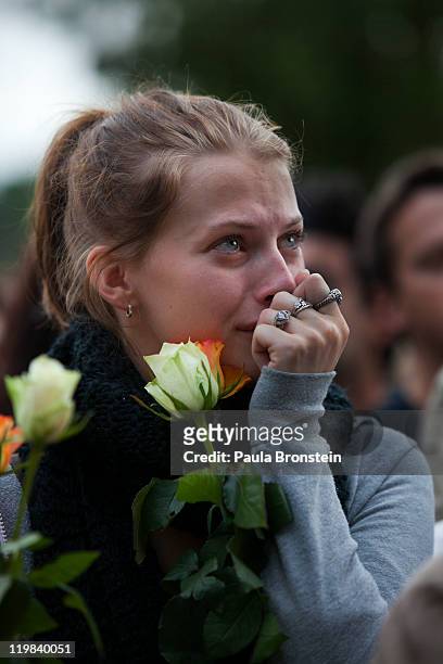 Norwegian woman reacts as hundreds of thousands of people gather at a memorial vigil following Friday's twin extremist attacks, July 25, 2011 in...