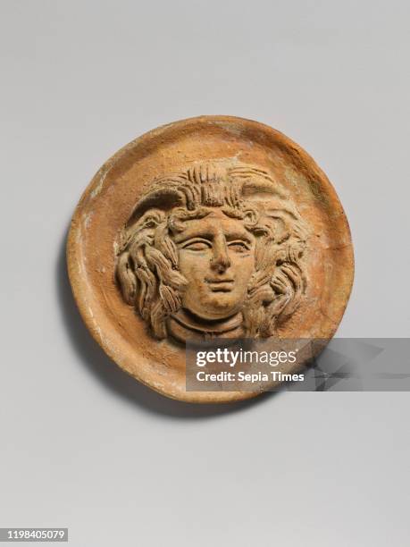 Terracotta reilef roundel with head of Medusa, Hellenistic, 2nd century B.C. Greek, Terracotta; mold-made, H. 3 1/16 in. , Terracottas, The central...