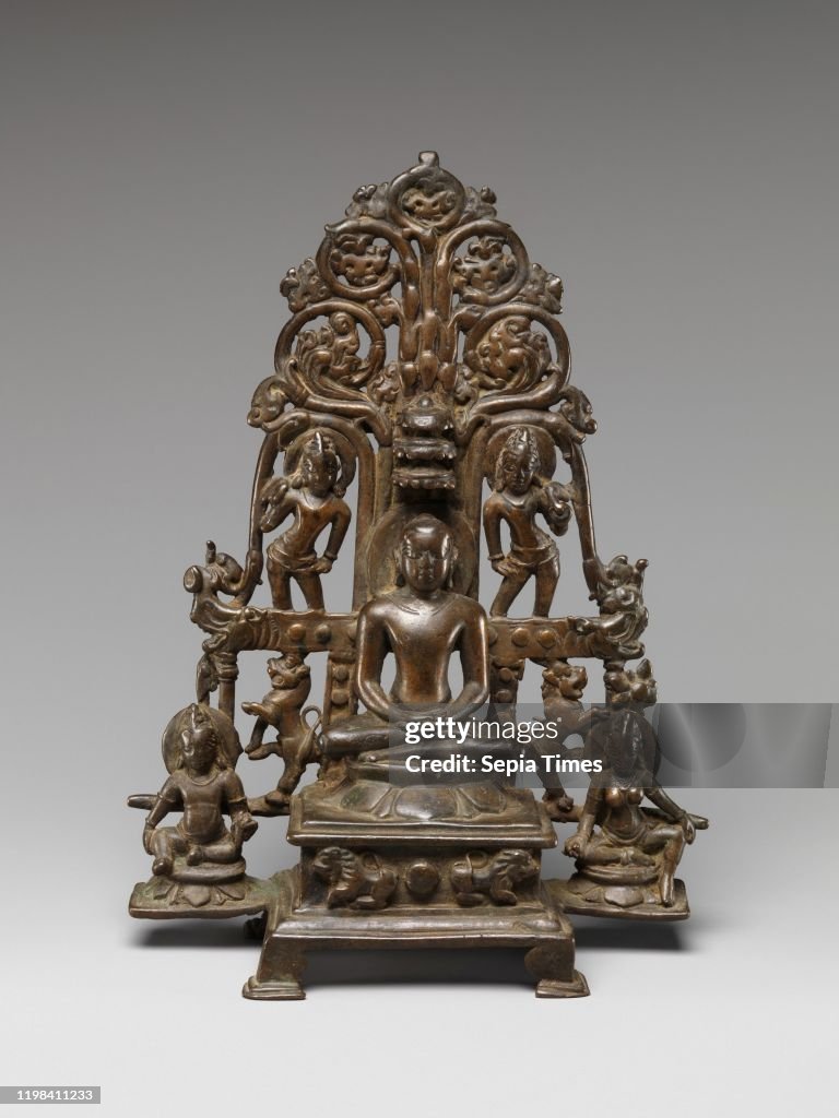 Enthroned Jina Attended by a Yaksha, a Yakshi, and Chauri-Bearers.