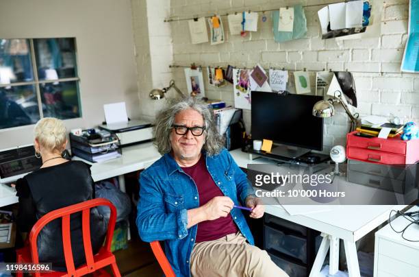 portrait of senior man in creative home office - creative director stock pictures, royalty-free photos & images