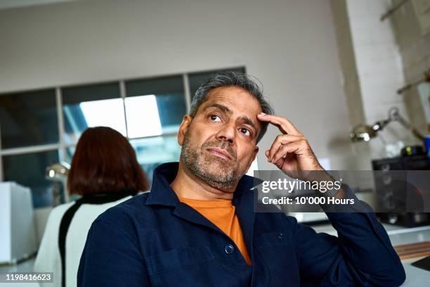 portrait of small business owner with hand on head thinking - older man real life stock pictures, royalty-free photos & images