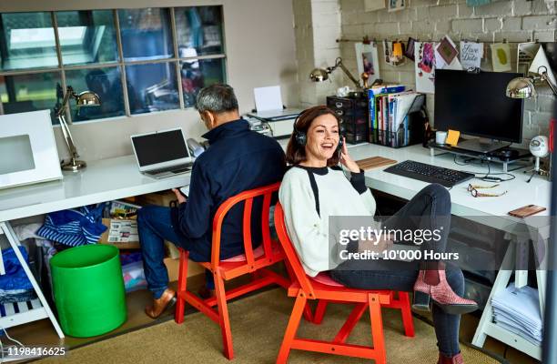 cheerful mature woman on phone call in home office - marketing small business stock pictures, royalty-free photos & images