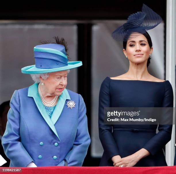 Queen Elizabeth II and Meghan, Duchess of Sussex watch a flypast to mark the centenary of the Royal Air Force from the balcony of Buckingham Palace...