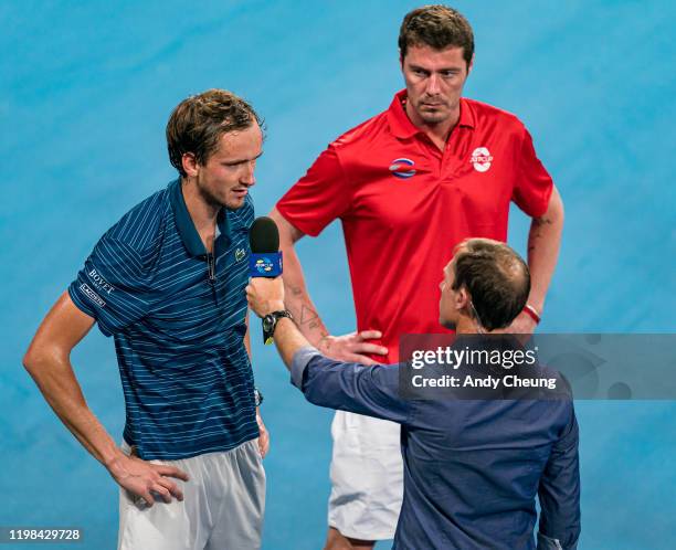 Daniil Medvedev of Russia gives a court side interview, while Russia Team Captain Marat Safin looks on, after winning match point during his quarter...