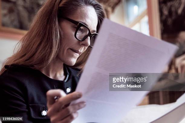 low angle view of female professional analyzing documents at law firm - document stock pictures, royalty-free photos & images