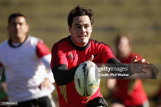 Zac Guildford of the All Blacks passes the ball during a New Zealand All Blacks training session at Rugby League Park on July 26, 2011 in Wellington,...