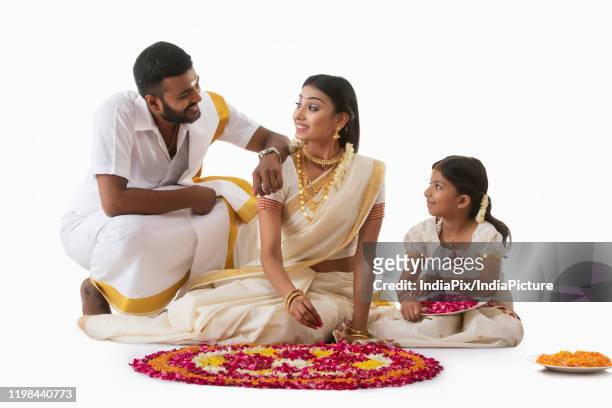 south indian family celebrating onam - onam stock pictures, royalty-free photos & images