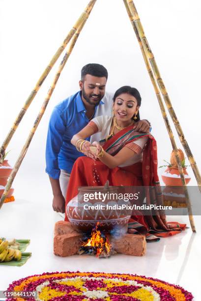 husband and wife cooking together on pongal - pongal festival stock pictures, royalty-free photos & images