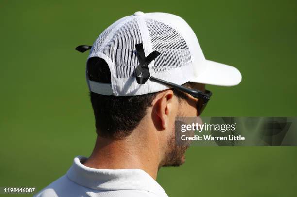 Players are seen wearing a black ribbon in remembrance of caddie James Rae during Day 1 of the South African Open at Randpark Golf Club on January...