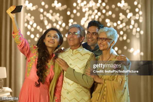 indian family taking selfie or self photograph at home on diwali festival - father clicking selfie stock pictures, royalty-free photos & images