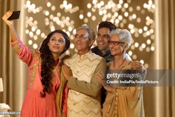 indian family taking selfie or self photograph at home on diwali festival - father clicking selfie stock pictures, royalty-free photos & images