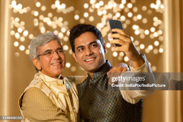 son aking selfie or self portrait with father using smart-phone in diwali festival - father clicking selfie bildbanksfoton och bilder