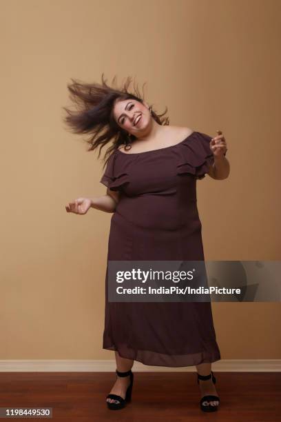 fat woman in a long brown dress dancing on high heels - fat women in high heels 個照片及圖片檔