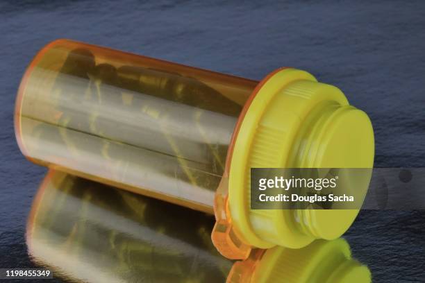 medicine pill bottle tipped over on its side - opioid epidemic stock pictures, royalty-free photos & images