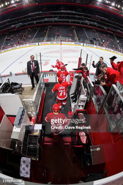 Goaltender Jimmy Howard of the Detroit Red Wings leads teammates Darren Helm, Dylan Larkin and Patrik Nemeth onto the ice during warm-ups prior to an...