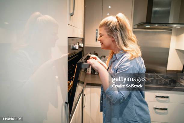 checking on the food - peeking stock pictures, royalty-free photos & images