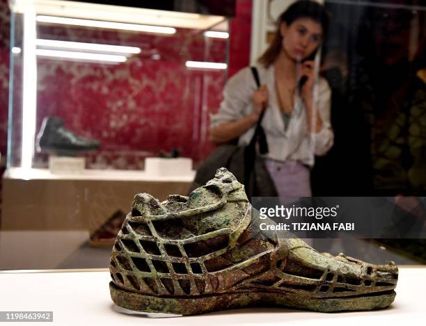 Visitor views a sculpture during the exhibition "Worn by the Gods" at the Fashion and Costume Museum in Palazzo Pitti in Florence on January 30,...