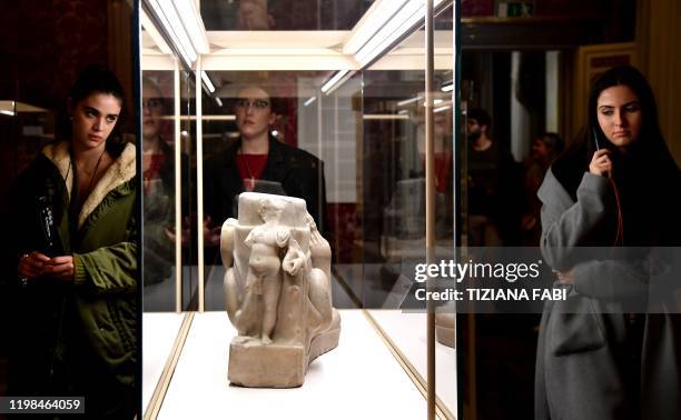 Visitors view a sculpture during the exhibition "Worn by the Gods" at the Fashion and Costume Museum in Palazzo Pitti in Florence on January 30,...