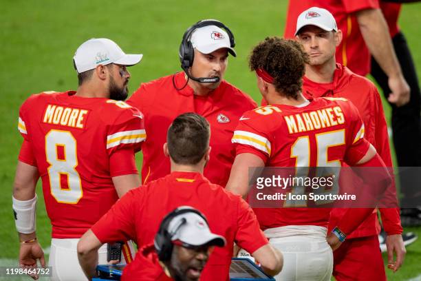 Kansas City Chiefs Quarterback Patrick Mahomes speaks with Kansas City Chiefs Quarterbacks Coach Mike Kafka and Kansas City Chiefs Quarterback Matt...