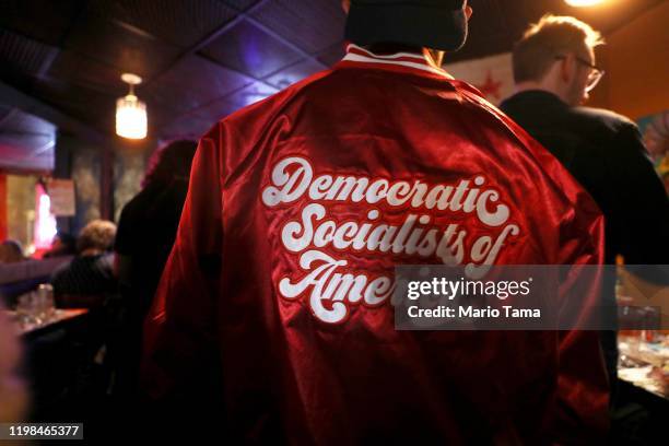 An attendee wears a jacket at an Iowa caucus watch party with supporters of Democratic presidential candidate Sen. Bernie Sanders , organized by...