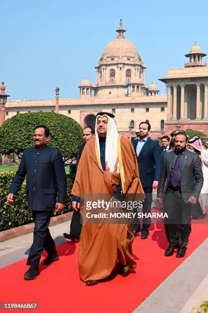 Indian Minister of State for Defence Sripad Naik and Minister of State for Defence Affairs of Qatar Khalid bin Mohamed Al Attiyah walk before...