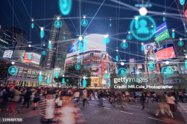 people and technology concept,global communication icon with network connections line above crowded people walking .internet of things and smart city concept,technology-futuristic concept - informationsüberflutung stock-fotos und bilder