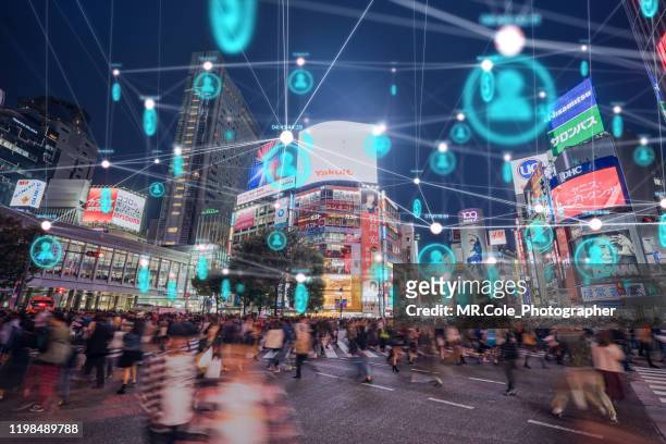 people and technology concept,global communication icon with network connections line above crowded people walking .internet of things and smart city concept,technology-futuristic concept - inserzione pubblicitaria foto e immagini stock