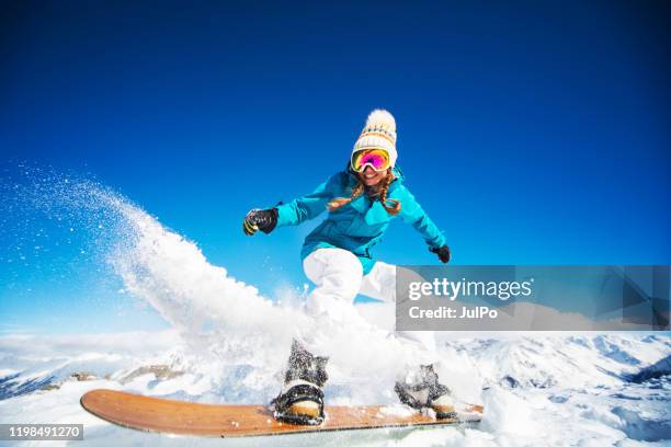 ski holidays - woman snowboarding stock pictures, royalty-free photos & images