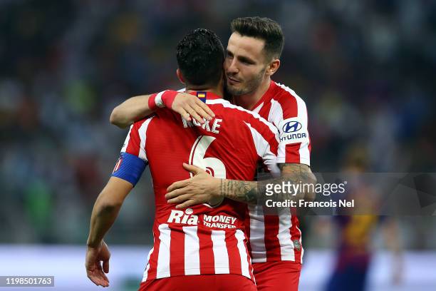 Koke of Athletico Madrid celebrates with Saul Niguez after scoring the first goal during the Supercopa de Espana Semi-Final match between FC...