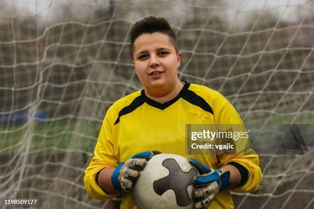 female goalkeeper holding soccer ball. - woman goalie stock pictures, royalty-free photos & images