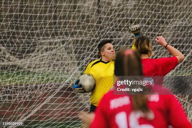 female goalkeeper celebrating defence. - woman goalie stock pictures, royalty-free photos & images