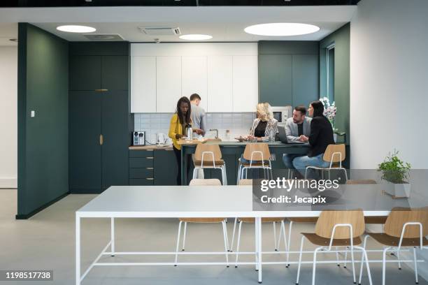 colleagues taking a break in the cafeteria - caffetteria stock pictures, royalty-free photos & images