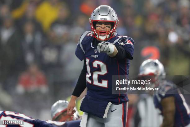 Tom Brady of the New England Patriots yells to teammates on the field during the the AFC Wild Card Playoff game against the Tennessee Titans at...