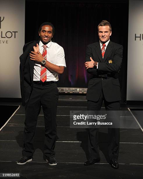 Manchester United footballers, Anderson and Tom Cleverley walk the runway during Hublot "Art of Fusion" fashion show with Sir Alex Ferguson &...