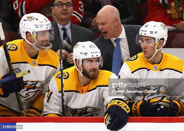 Head coach John Hynes of the Nashville Predators gives instructions to players on the bench during a game against the Chicago Blackhawks at the...